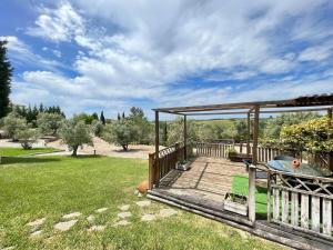 a wooden deck with a gazebo in a yard at Casa dos Cedros in Bicas