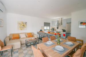 a living room with a table and a couch at Casas Caiado Two Houses with swimming POOL in Faro