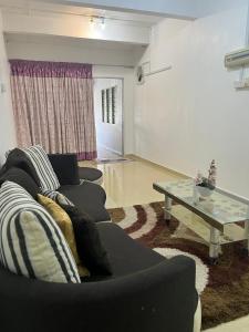 a living room with a couch and a table at Homestay Jerantut in Jerantut