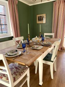 a wooden table with plates and dishes on it at Ferienhaus Bothmer in Schwarmstedt