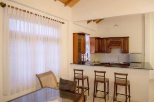a kitchen with a table and chairs and a counter at Paradise Bay in Beruwala