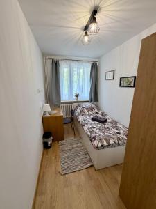 a bedroom with a bed and a ceiling fan at Muranów Rooms Warsaw in Warsaw +12 photos