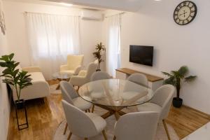 a living room with a glass table and chairs at Apartment LANA in Čapljina
