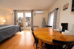 a bedroom with a wooden table and a bed and a table and chairs at The Whitetail Inn and Suites- Lincoln in Lincoln