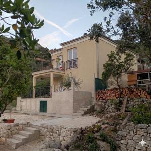 a house with a staircase in front of it at VILA ROZA in Prožura
