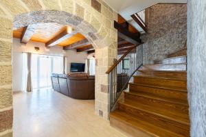 a hallway with a staircase and a stone wall at Villa Azzurra in Krstac +35 photos