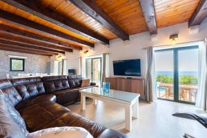 a living room with a couch and a table at Villa Azzurra in Krstac