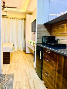a kitchen with a sink and a counter top at Gr Noida Stay & BNB in Greater Noida