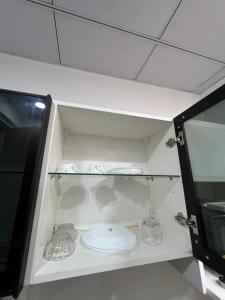 a cabinet with two dishes and a plate in it at Gr Noida Stay & BNB in Greater Noida