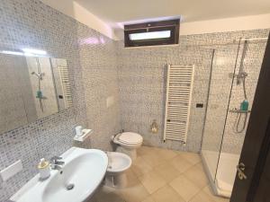 a bathroom with a sink and a toilet and a shower at Residenza Borgo Francescano in Gioia del Colle +33 photos