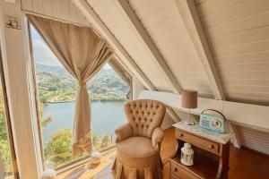 a room with a chair and a large window at Miragem do Douro in Marco de Canaveses