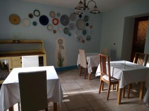 a dining room with tables and chairs and plates on the wall at Villa Rosalena in Bagni di Lucca