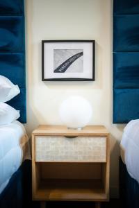 a table with a bowl on it next to two beds at The Speckled Trout Outpost in Damascus