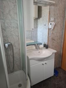 a bathroom with a sink and a shower at Apartmani MM in Tkon +34 photos