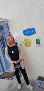 a woman standing in front of a wall with signs at gite du canal in Ormoy