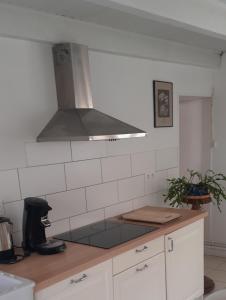 a kitchen with a stove top oven in a kitchen at gite du canal in Ormoy