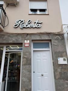 a door to a store with a sign above it at Berta Home in Mota del Cuervo