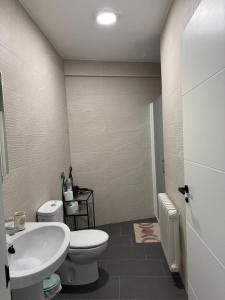 a bathroom with a white toilet and a sink at Berta Home in Mota del Cuervo +36 photos