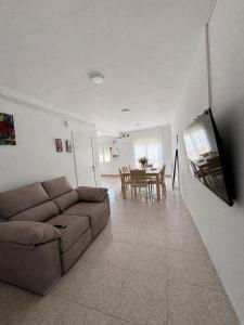 a living room with a couch and a table at Berta Home in Mota del Cuervo