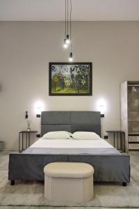 a bedroom with a large bed and two stools at Bellosguardo Suites in San Paolo Bel Sito
