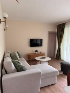 a living room with a couch and a table at Hil's Bay View - Terra in Lepetani