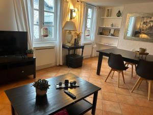 a living room with a table and a dining room at Duplex in Honfleur