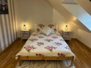 a bed in a room with two night stands at Duplex in Honfleur