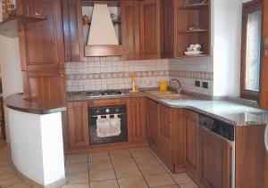 a kitchen with wooden cabinets and a stove top oven at Le Maree Susanna in Rio Marina