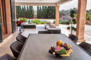 a plate of fruit on a table in a room at Villa Santa María Dreams AWARDED 2024 in Santa Maria del Camí