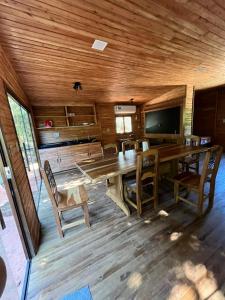 a dining room with a large wooden table and chairs at Campo Eden in Capitán Miranda