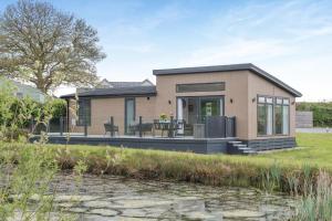 a small house with a patio and a pond at 2 Bed in Canaston Bridge oc-d34702 in Robeston Wathen
