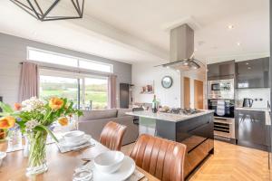 a kitchen with a table with a vase of flowers at 2 Bed in Canaston Bridge oc-d34702 in Robeston Wathen +23 photos