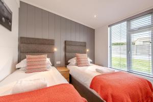 a bedroom with two beds and a window at 2 Bed in Canaston Bridge oc-d34702 in Robeston Wathen