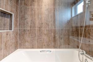 a bathroom with a tub and a glass shower at 2 Bed in Canaston Bridge oc-d34702 in Robeston Wathen