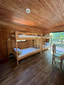 two bunk beds in a room with a wooden ceiling at Campo Eden in Capitán Miranda