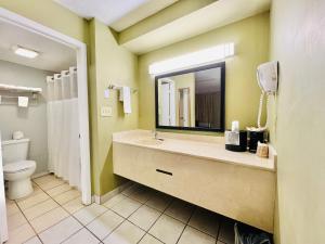 a bathroom with a sink and a toilet and a mirror at Hometown INN in Berea +36 photos