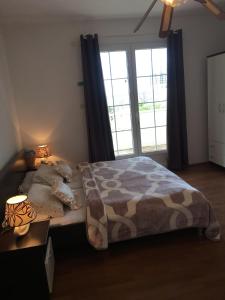 a bedroom with a bed and a large window at Guesthouse Alliya in Dubrovnik