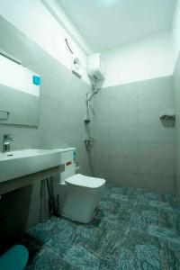 a bathroom with a toilet and a sink at Prime Inn Kandy in Kandy