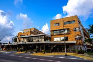 a tall brick building on a city street at Bessa Beach Hotel in João Pessoa