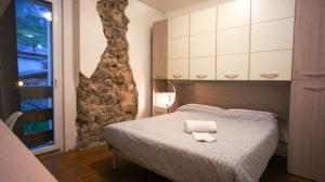 a bedroom with a bed with a towel on it at Casa Degara in Ledro