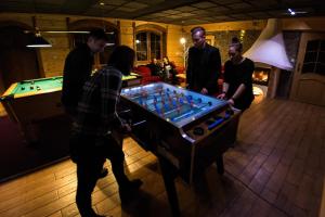 a group of people standing around a pool table at Mileżówka - Noclegi&SPA in Ustroń