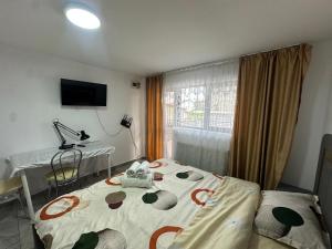 a room with two beds and a table and a television at Nord Accomodation in Bucharest