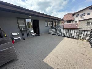 a patio with two chairs and a fence at Nord Accomodation in Bucharest