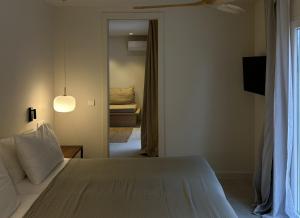 a bedroom with a bed and a door to a room at Serena Sol Apartments - Adults Only - Over 12 in Cala Serena +24 photos