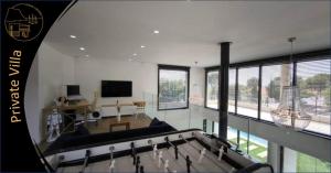 a large living room with a couch and a tv at Cassis Lodges in Cassis