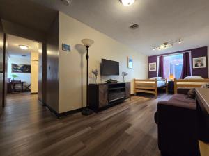 a living room with a couch and a television at Stay Pittsburgh in Pittsburgh