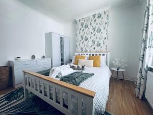 a bedroom with a bed with a wooden headboard at Lonsdale Terrace - 3 Bedrooms - Sleeps 6 in Workington