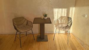 two chairs and a wooden table in a room at ЛІДІЯ in Yasinya