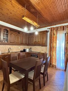 a kitchen with a dining room table and chairs at Xhoni House in Elbasan