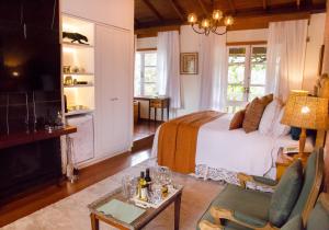 a bedroom with a bed and a living room at Pousada Rabo do Lagarto in Pedra Azul +219 photos